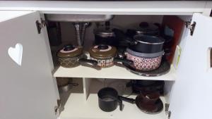 a cabinet filled with lots of pots and pans at MonteVerdeMG, Vista para Montanha ,fácil acesso, térrea, Pets in Monte Verde +18 photos