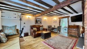 a living room with a couch and a table at Cosy Cottage in Wellington