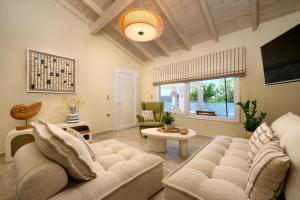 a living room with a couch and a table at Ninos Corfu Villas in Agios Georgios
