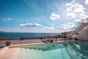 a swimming pool with a view of the ocean at LES SUITES LOVE 2 SPA VUE MER PISCINe in Marseille