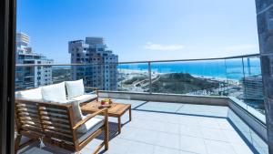 a balcony with a view of the ocean at O&O Group - SeaFront Luxurious 3 BR Apartment in Bat Yam