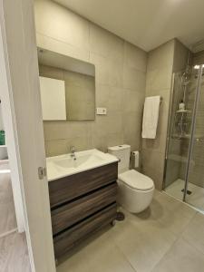 a bathroom with a sink and a toilet and a shower at Barquerina - Ría de Villaviciosa in Villaviciosa
