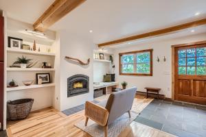 a living room with a fireplace and a chair at Trollhagen 5 Condo in Breckenridge +33 photos