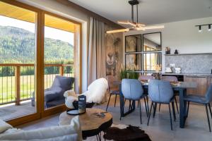 a living room with a table and chairs at Apartament Owca na wypasie by Apart Concept Podhale in Kościelisko