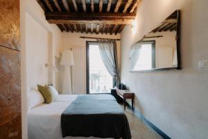 a bedroom with a bed and a window at Le stanze del Piccadilly in Genoa