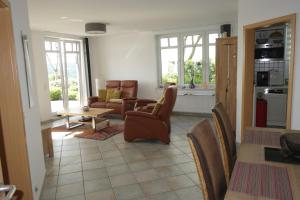 a living room with chairs and a table at Ferienwohnung der weite Blick mit Wellness in Winterberg
