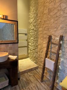 a bathroom with a sink and a mirror at La chambre l'Eucalyptus in Saint-Laurent-du-Bois