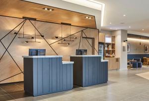 a lobby with two counters in a building at Courtyard by Marriott Stoke on Trent Staffordshire in Newcastle under Lyme