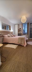 a bedroom with a large bed in a room at EMA Cottage in Montjean +36 photos