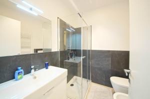 a bathroom with a sink and a glass shower at DolceVita Apartments N. 515 Redentore in Venice