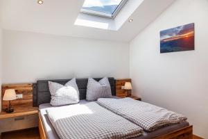 a bedroom with a bed and a skylight at Ferienwohnung Rosalie in Farchant