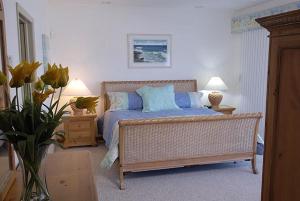a bedroom with a bed with blue pillows at Castaway Cove by Grand Cayman Villas & Condos in Driftwood Village