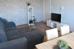 Televízia a/alebo spoločenská miestnosť v ubytovaní Panorama View Apartment