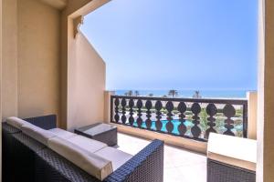 a balcony with chairs and a view of the ocean at Studio in Al Hamra Village with Sea View in Ras al Khaimah