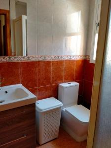 a bathroom with a toilet and a sink at Casa Panorama in Mazarrón