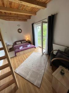 a bedroom with a bed and a staircase in a room at Rooms Ljubenko in Karlovac
