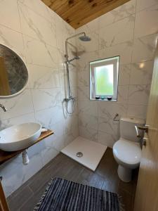 a bathroom with a sink and a toilet and a window at Rooms Ljubenko in Karlovac