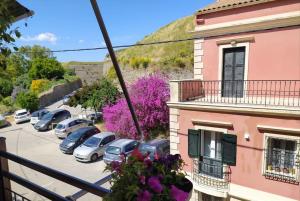a view from a balcony of a parking lot with cars at Xenofon's cozy apartment in Corfu