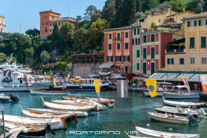a group of boats docked in a harbor with buildings at Casa Papù 2 by PortofinoVip in Portofino