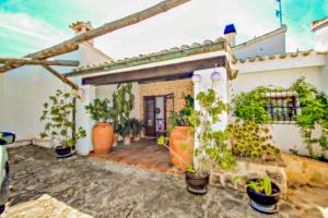 a house with potted plants on a patio at Finca La Coma - modern, well-equipped villa with private pool in Benissa in Benissa