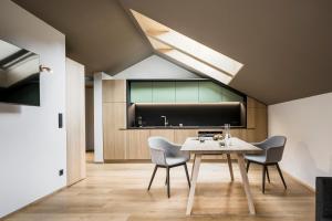 a dining room with a table and two chairs at freiraum Apartments in Mellau
