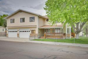 a house on a street with a tree at Charming Elko Home with Pool Table! in Elko