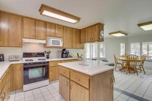 a kitchen with wooden cabinets and a table and chairs at Charming Elko Home with Pool Table! in Elko