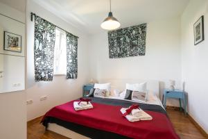 a bedroom with a bed with two towels on it at Apartments Karisima in Korčula