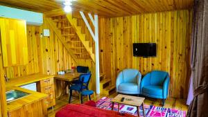 a room with two chairs and a table and a staircase at HAT NATUREL RESORT Sapanca in Sapanca