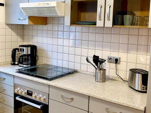a kitchen with a counter with a stove top oven at Ferienwohnung Fuldaufer in Melsungen