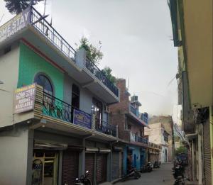 an alley with buildings and motorcycles parked on a street at Krishna Kunj Homestay Rishikesh in Rishīkesh