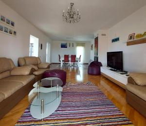 a living room with a couch and a coffee table at Relax to the max with the sea view in Medulin
