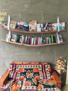 a shelf of books on a wall with a bed at AldeaPanoramica in Paul