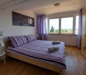 a bedroom with a bed with two pillows on it at Relax to the max with the sea view in Medulin +16 photos