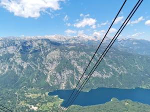 a view from a gondola flying over a lake at Chalet Burja at Vogel mountain - cable car access or hiking - not reachable with car in Bohinj