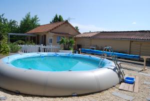 a large inflatable pool in front of a house at LANA COTTAGE 3 Etoiles in Montjean