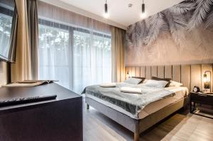 Llit o llits en una habitació de Apartamenty Premium Shellter Rogowo - ALL DAY HOLIDAY