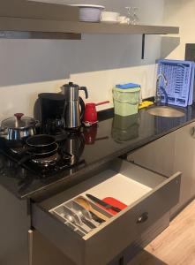 a kitchen counter with a sink and a stove at Lovely Flat with Balcony near Hadrian's Gate in Antalya