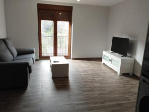 a living room with a couch and a flat screen tv at Canadina 1 in Morgovejo