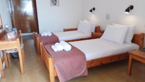 a room with two beds with white pillows on them at Loggia in Agia Galini