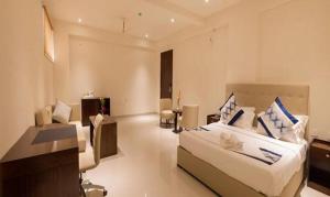 a hotel room with a bed and a living room at FabHotel Prime Manasa Inn in Tirupati
