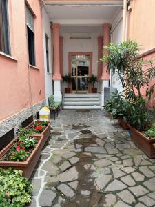 a building with a courtyard with flowers and plants at Hotel Mercurio in Milan