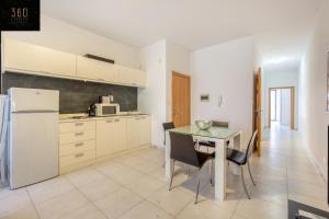 A kitchen or kitchenette at Modern & private 1BR APT in the Heart of Paceville by 360 Estates