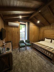 a bedroom with a large bed and two chairs at LE CHALET MONT And RESTAURANT in Chorwoq