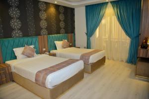 Voodi või voodid majutusasutuse Jasmine Pyramids Hotel toas