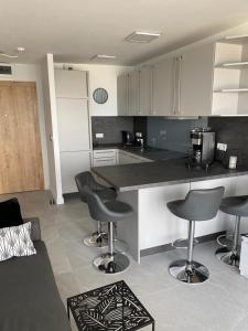 a kitchen with a counter and some bar stools at Porta Mare - Dziwnówek - Ferienappartment an der polnischen Ostsee in Dziwnówek