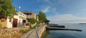 a building on the side of a body of water at Beachfront House Ugor in Lun