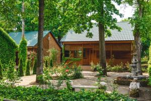 a cabin in the woods with trees and flowers at Sovinyon Resort in Odesa