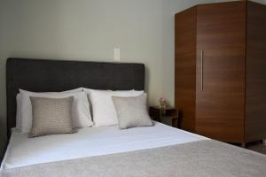a bedroom with a large bed and a wooden cabinet at Anastasia mare home #A# in Rethymno