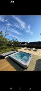 a hot tub sitting on top of a deck at Sikvägen Apartments in Mariehamn